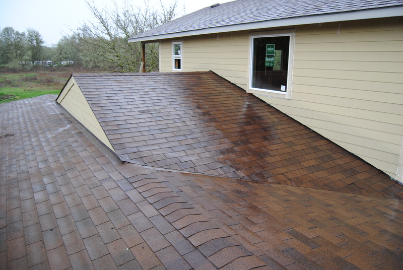 View of the Cricket which directs water run-off away from the house. Notice that the shingles are complete.