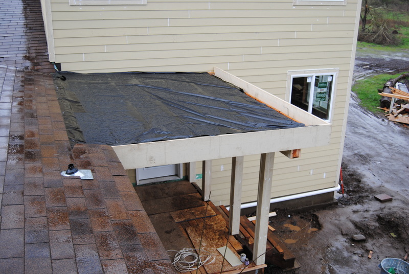 Portico roof, temporary covering. View of the front porch from above.
