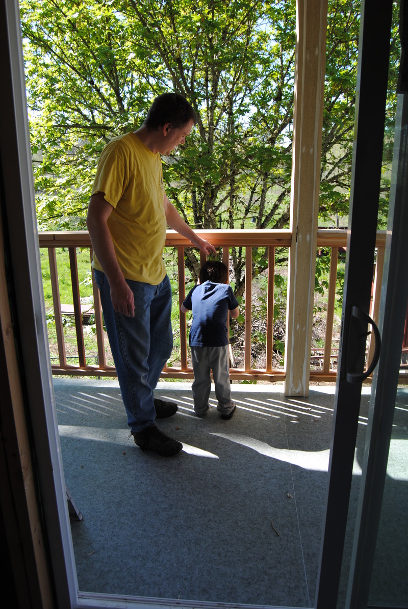 Kili and Joseph checking out the sliding door and balcony.