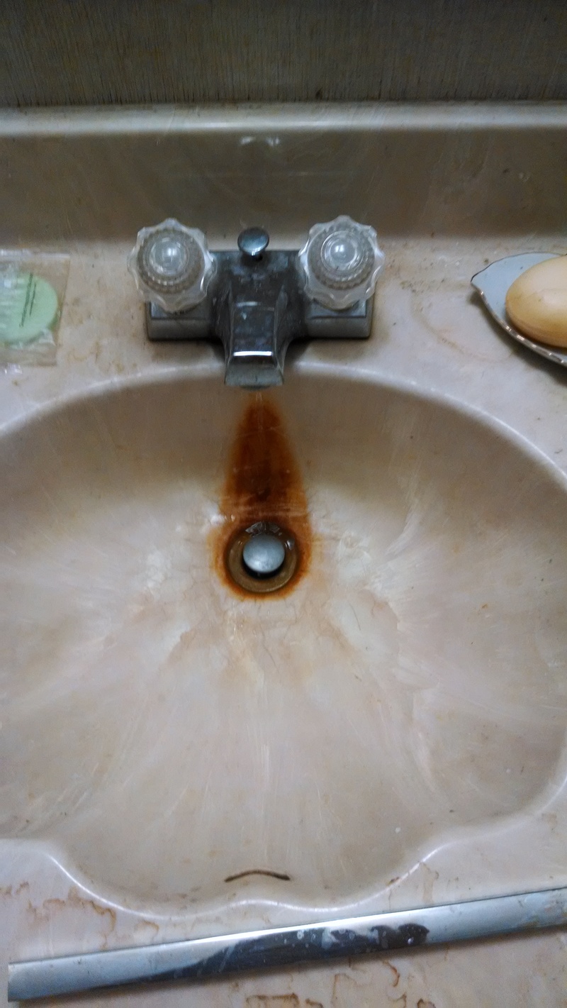 Old drippy sink in the master bathroom.