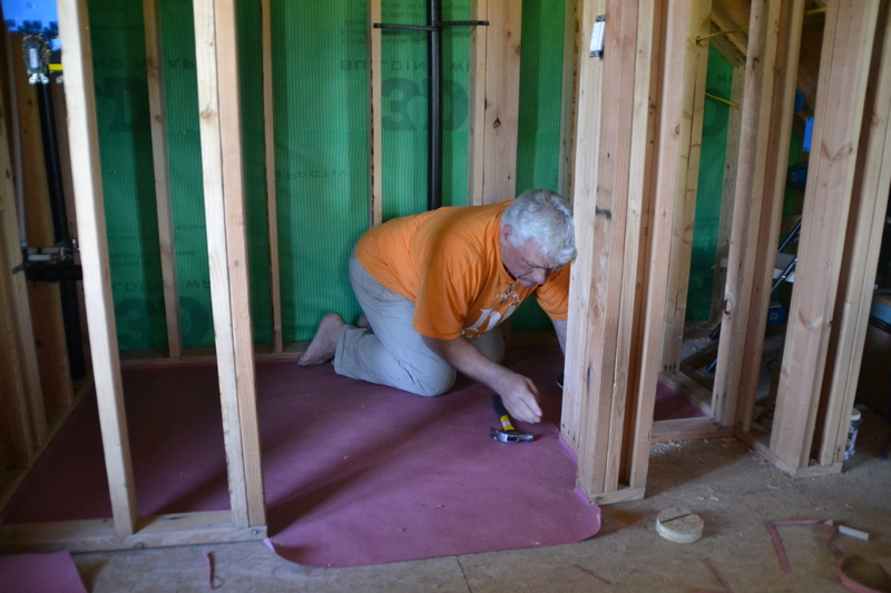 Don is putting the staples in, and next the under layment goes on.