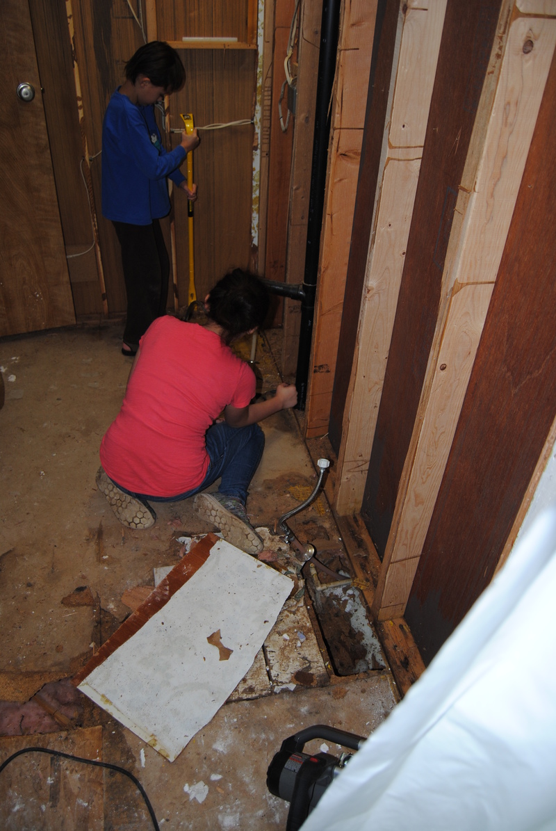 Alex and Shannon removing flooring.