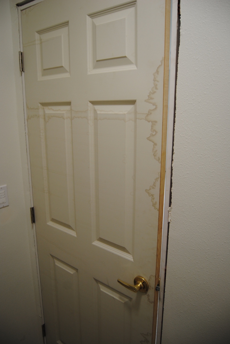 Don's bathroom. Hinges by light switch. Also notice the water damage, possibly caused by being stored outside.