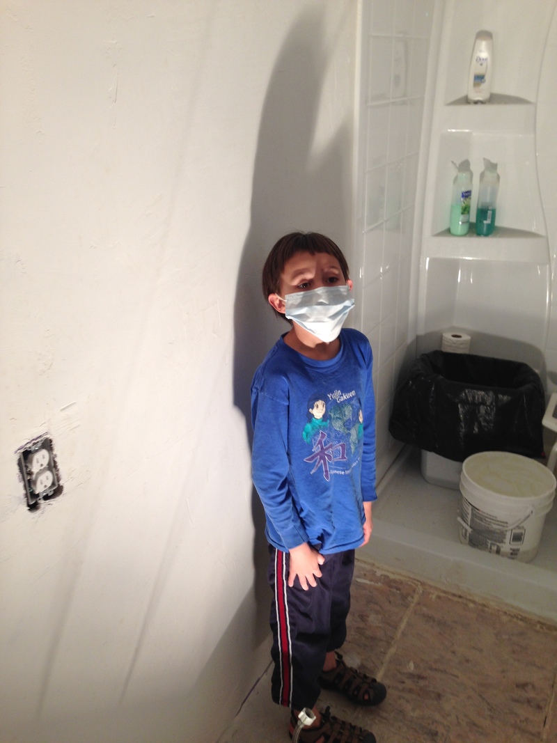 Alex sanding the bathroom wall.  Well, maybe taking a break.