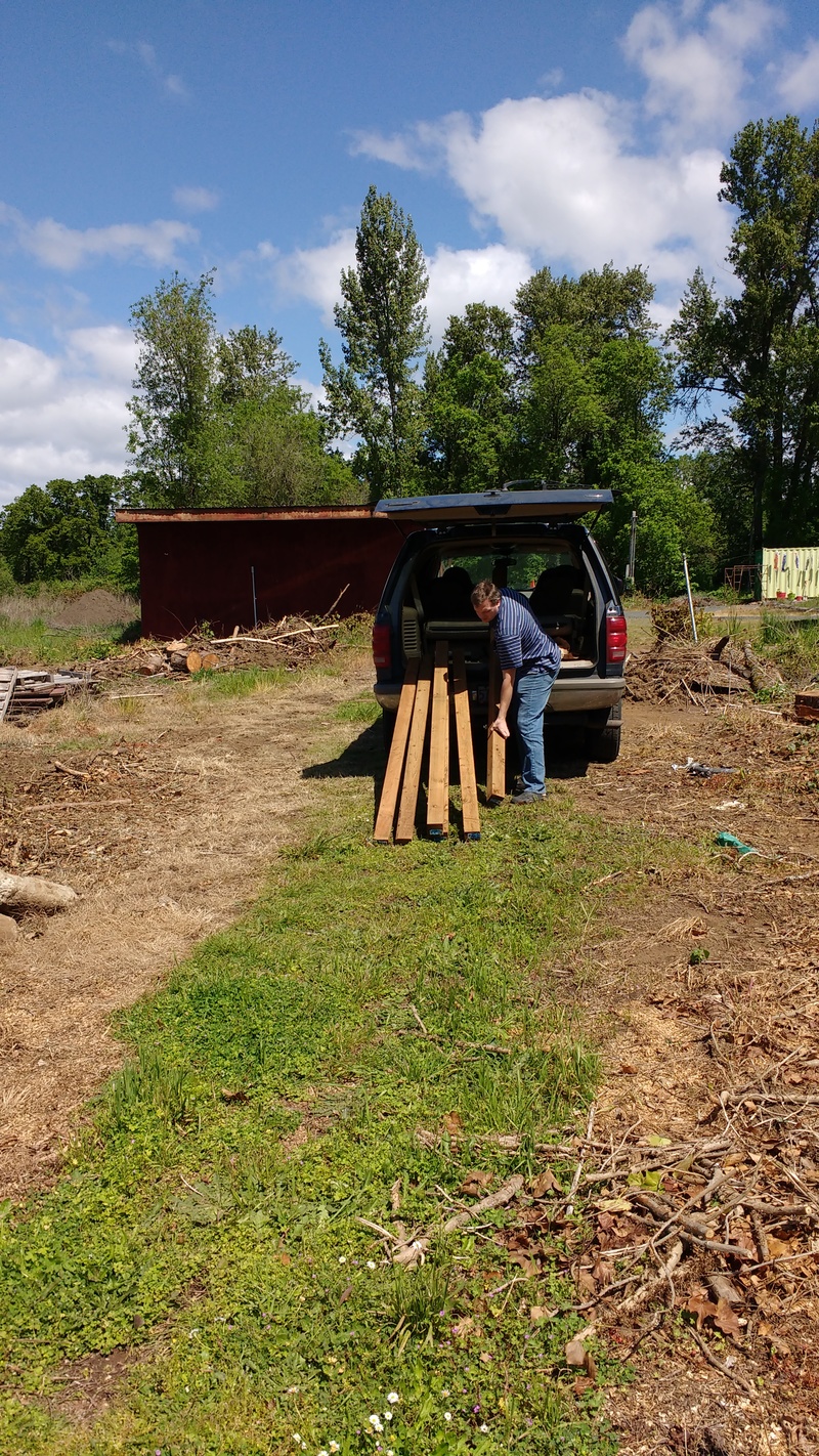 Joseph unloading wood for the chicken coop.