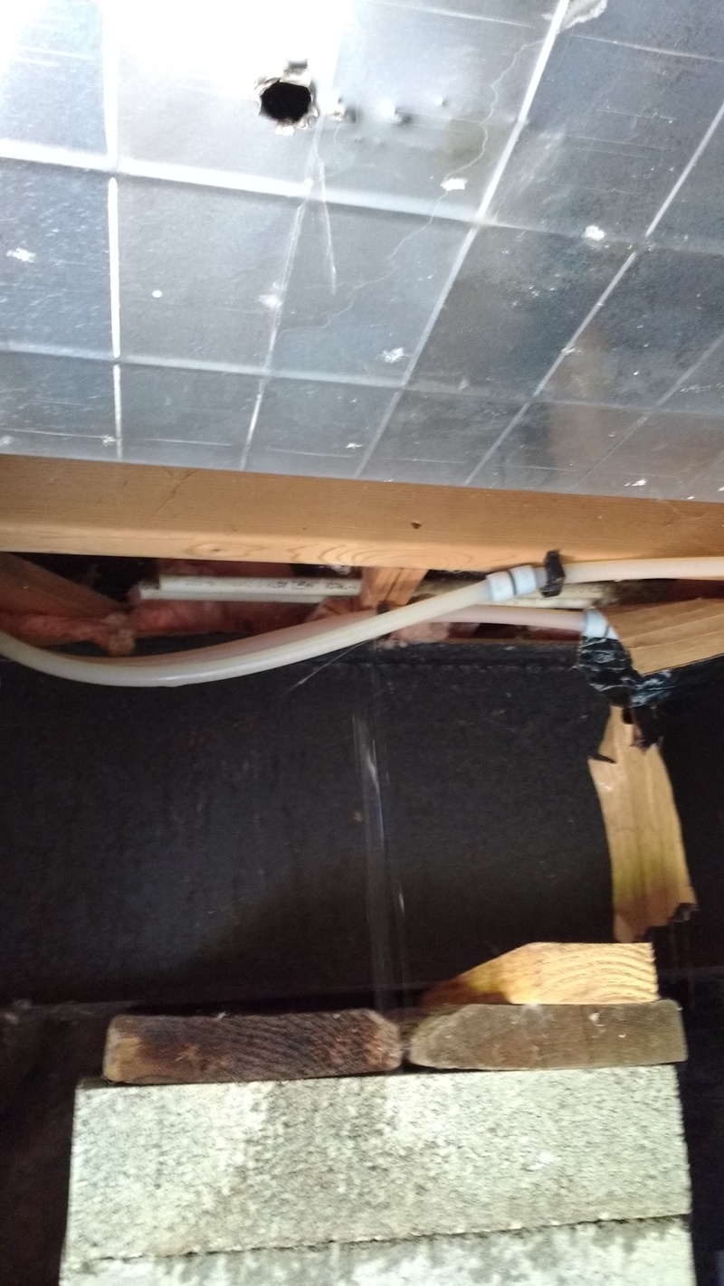 Here is a hole I made in the duct work below the bathroom.  Water was collecting in the duct.  The duct was not being used for heating any more, so I poked a hole in the lowest spot so the water could escape.
