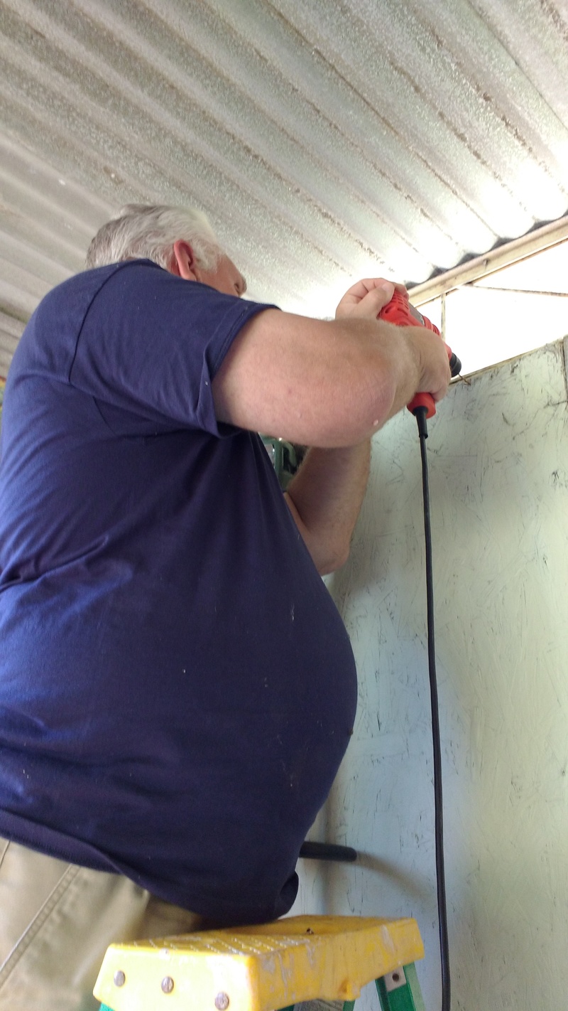 Don adds long screws at the top of the wall for hanging tools.