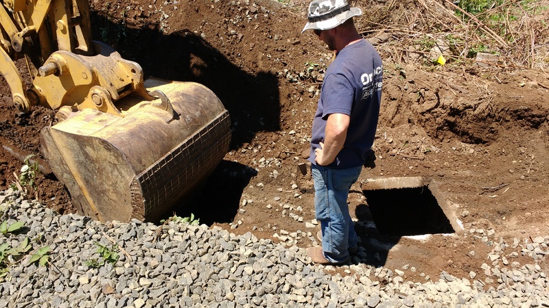Old septic system tank is being uncovered and will be destroyed.