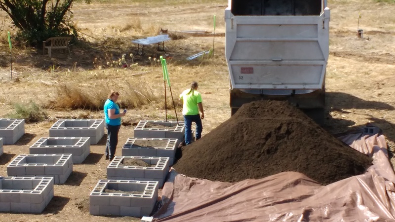 First load of potting soil. Lois and worker.