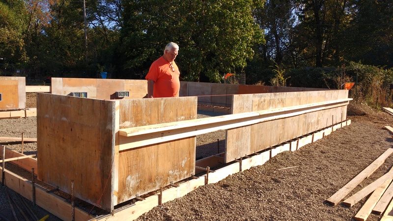 Don looking at the first layer of foundation for the garage/greenhouse.