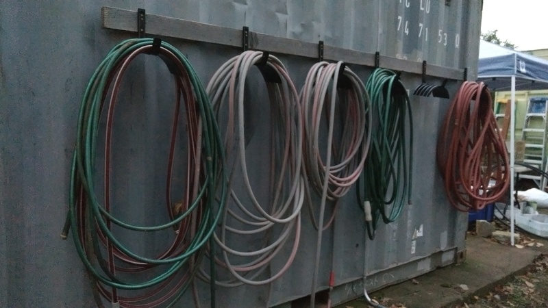 Don and Lois got metal hangers and installed them behind her container. Then they hauled hoses all over the property and put them away for the winter.
