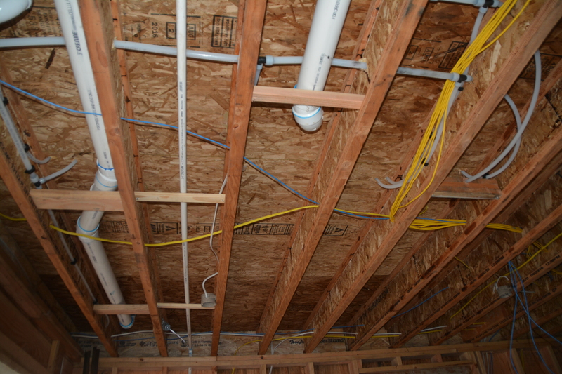 garage inside northeast corner ceiling, showing plumbing and network wiring.