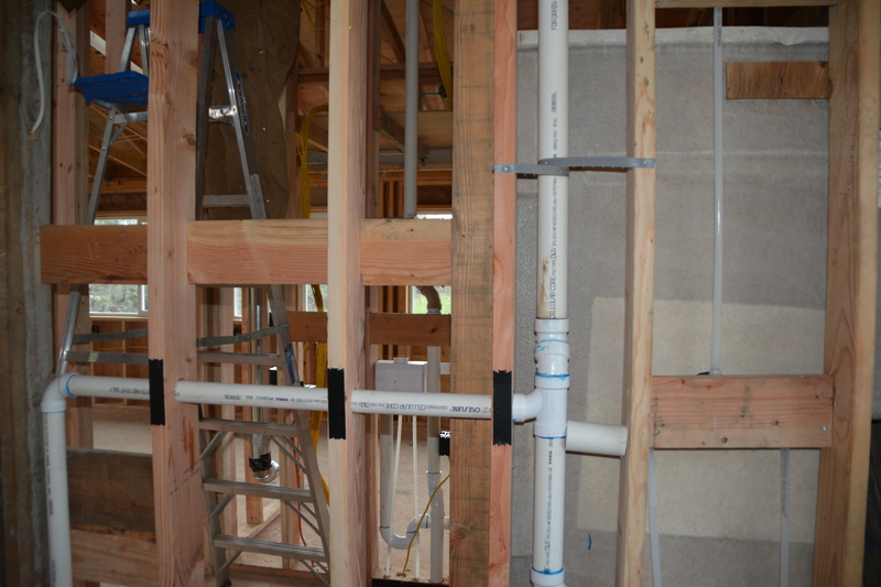 guest house outer bathroom west wall showing shower plumbing.