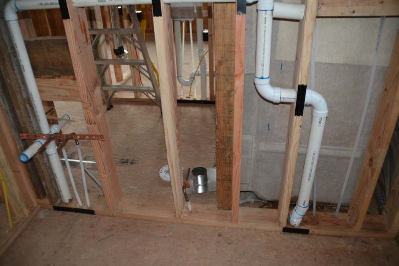 guest house outer bathroom west wall showing shower plumbing and sink plumbing.
