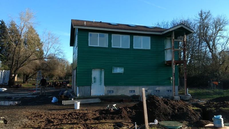 West face of the guest house. There will be a stairway between the two doors.