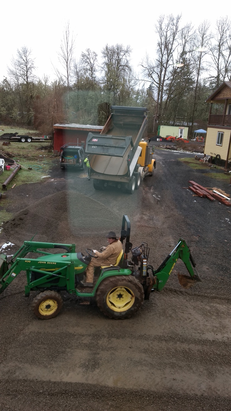 Kent moves gravel to improve the grading around the guest house.