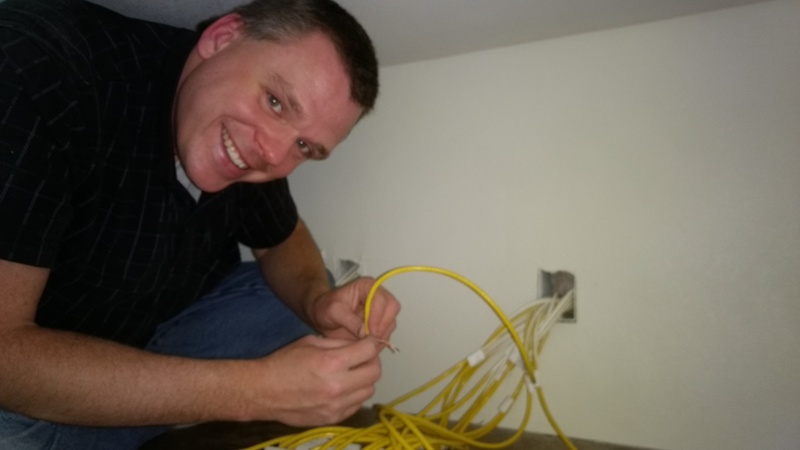 Joseph up in the washer / dryer nook terminating Cat6 network wiring.