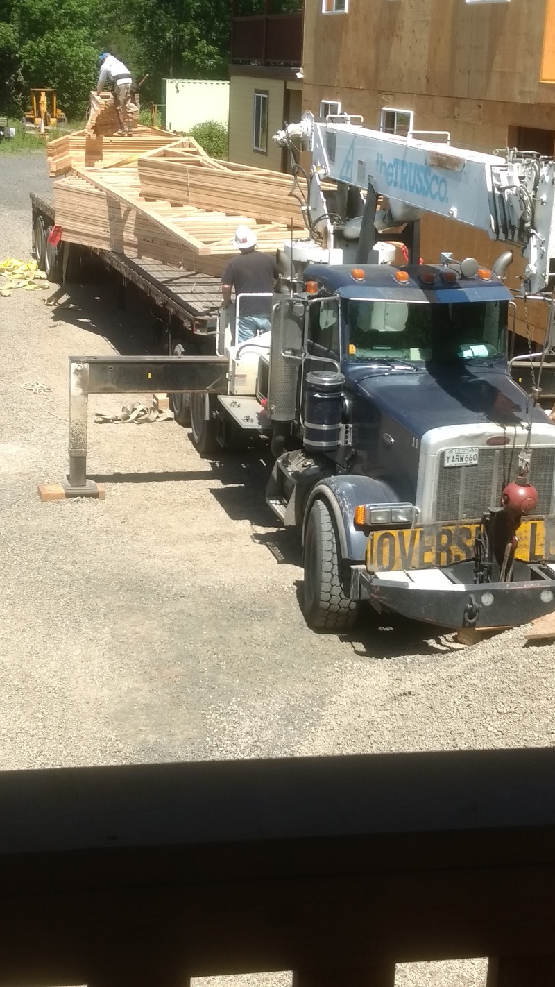 The truck has legs, extended now, to support the crane.