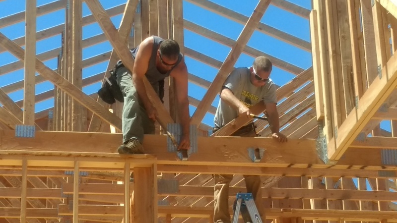 Hammering trusses into place.