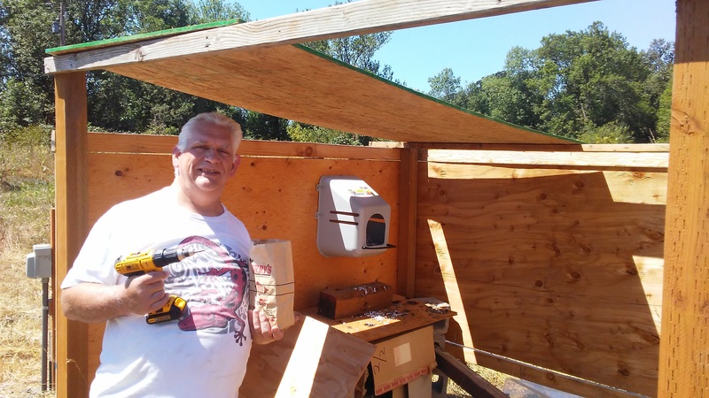 Improvements to the hen house. Notice the laying box on the wall. Notice Don holding the drill and screws that Joseph used to put everything together.