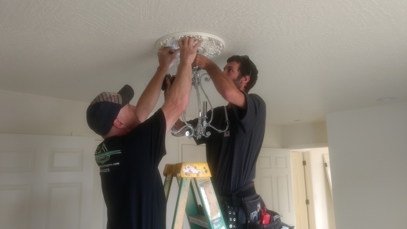Installing the chandelier in Master Bedroom