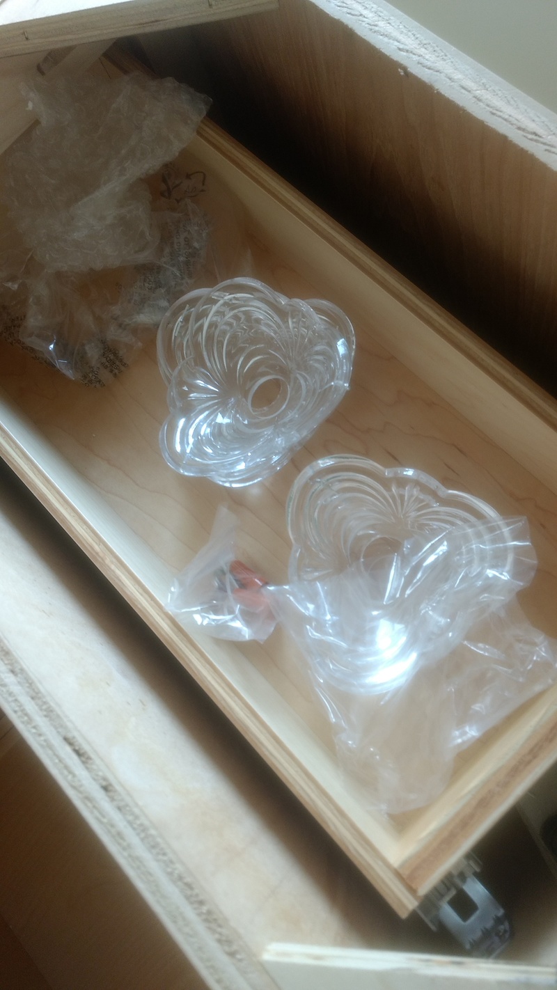 Chandelier parts in the bathroom cabinet drawer that is sitting in the Master Bedroom