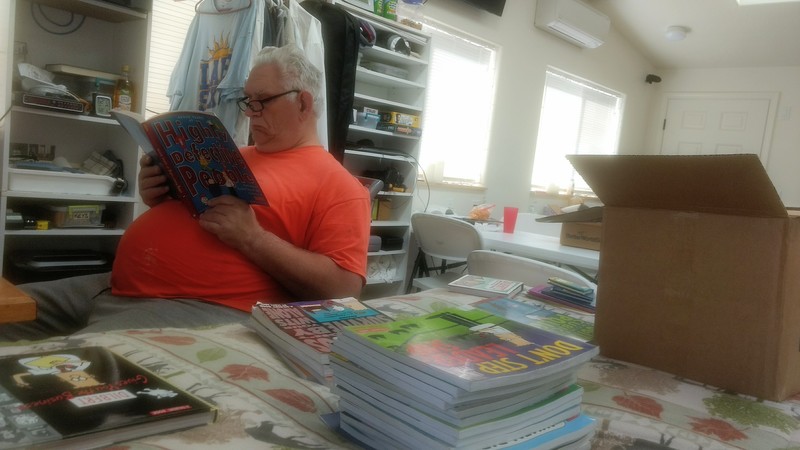 Don reads a Dilbert book, Seven Years of Highly Defective People