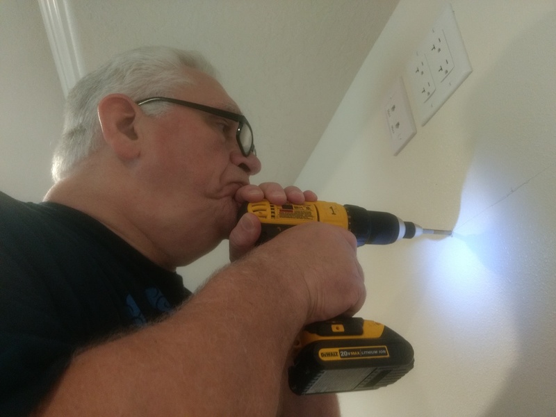 Don drills the first hole for the TV mount in rm9