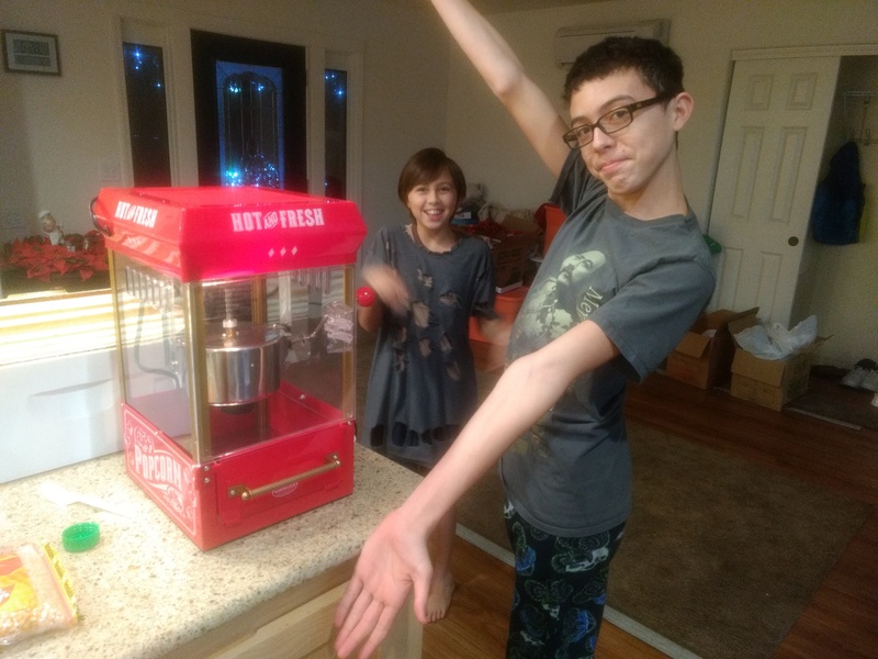 Mikey shows off our new popcorn popper.