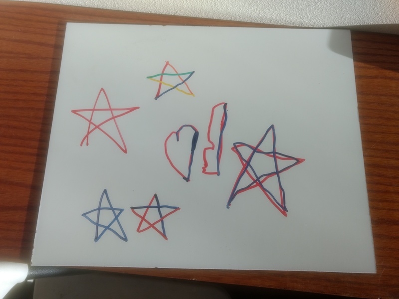 Seeing Stars: Kekoa used our new dry erase (white board) pens to mark a leftover scrap of the white board. He was very happy with the work he did.