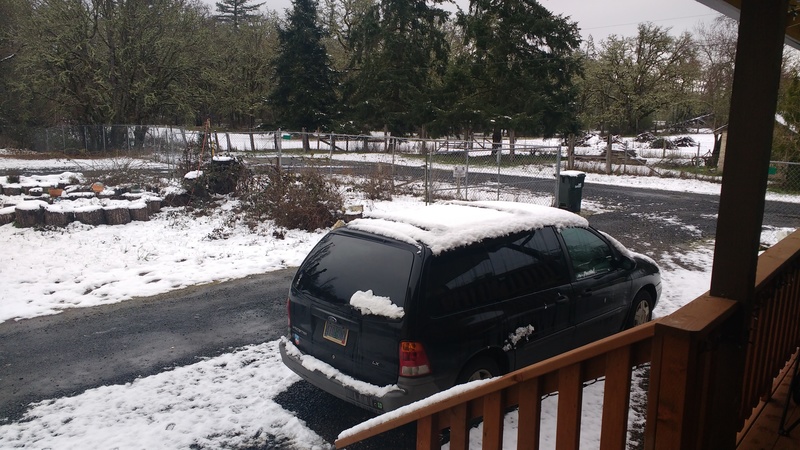Isaac shows the snow accumulation at Rosewold. Looking northeast from the front porch deck, featuring snow on top of our black minivan.