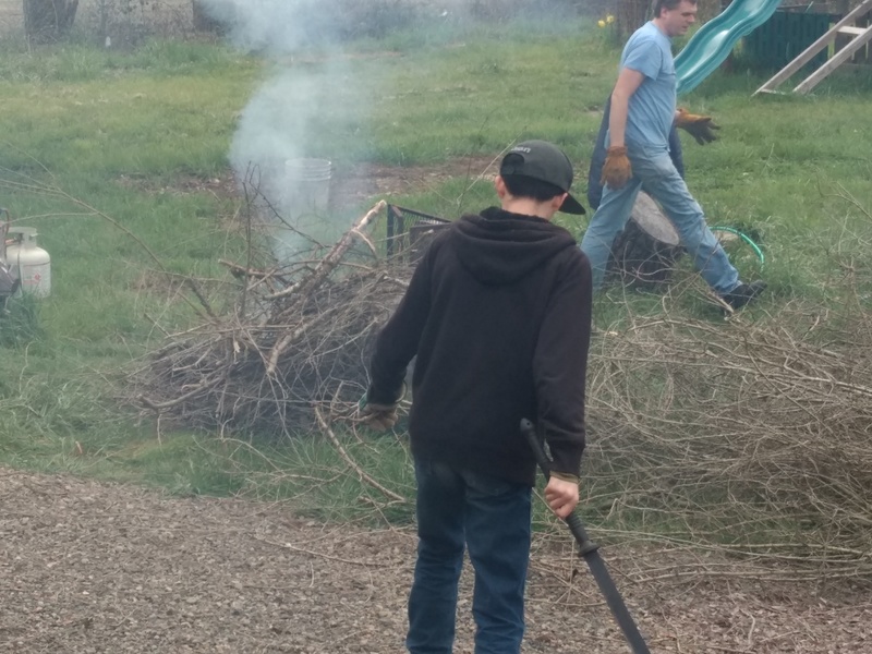 Firepit; Mikey with machete and Joseph with gloves.