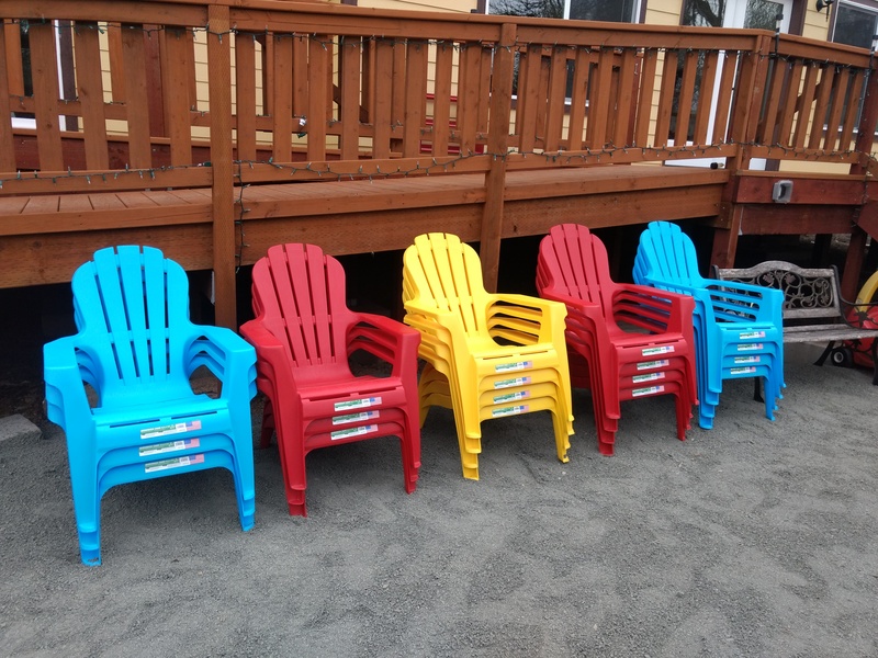 18 colorful Adirondack chairs that we got at Walmart.