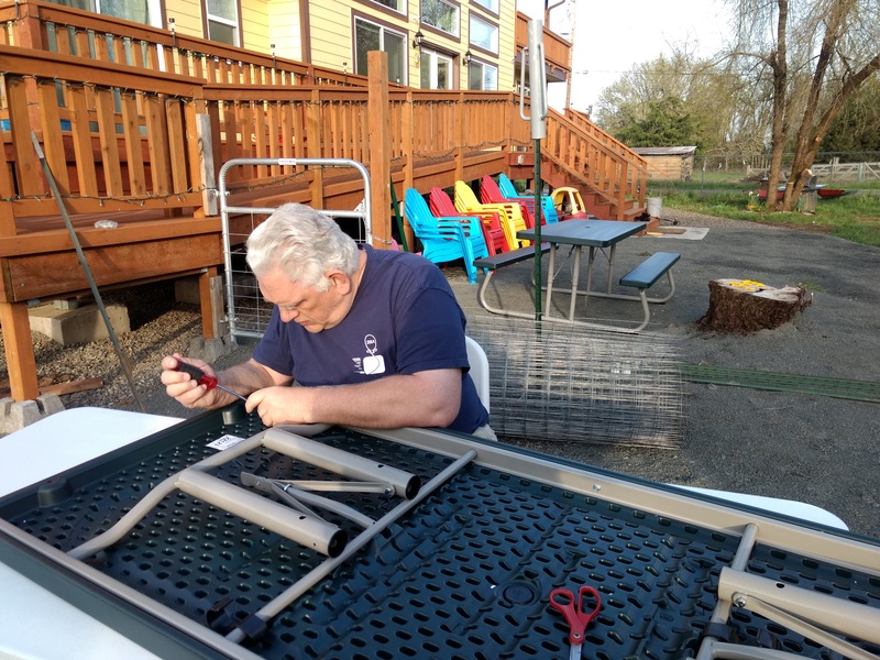 Don building the fourth picnic table.