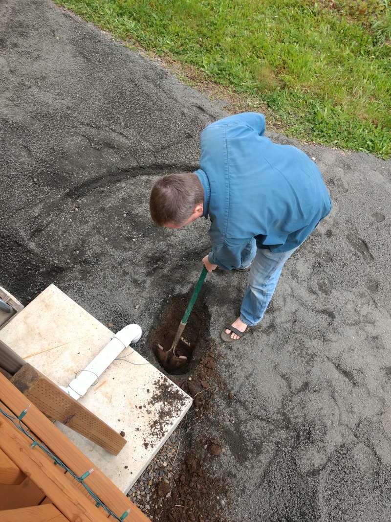 Joseph digs post hole for the west side of the new gate in the East Garden.