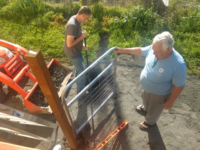 Don inspects the swing of the new gate in East Garden.