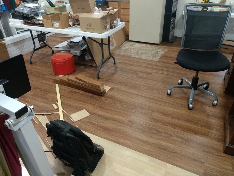 12 feet by 16.66 feet of dark flooring is done.  Additional rows of light (temporary) flooring have been added.