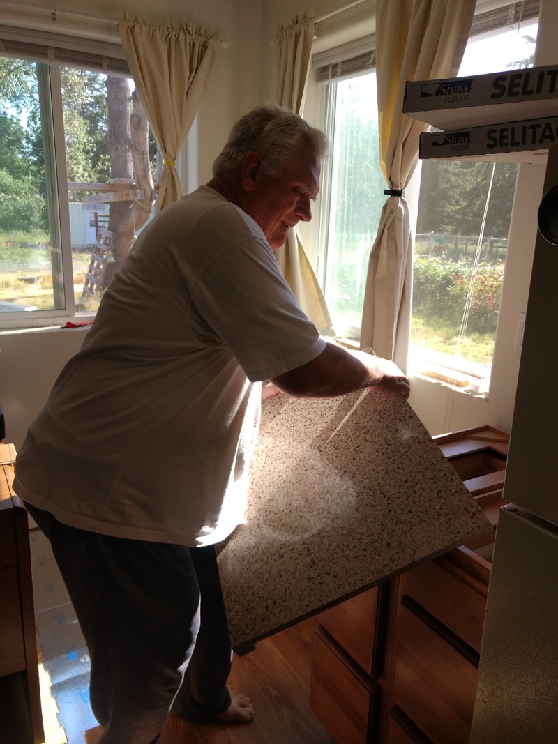 Don replaces the quartzite countertop on which the microwave will rest.