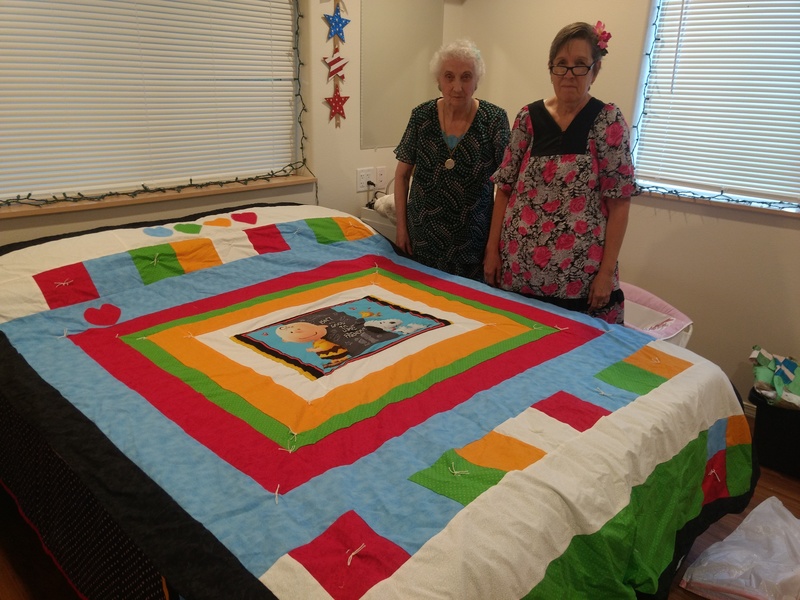 Cindy showing the quilt she made for Isaac and Stephanie.