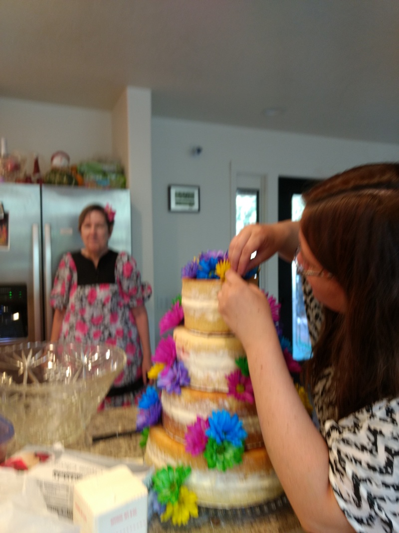 Dina putting flowers on the cake.