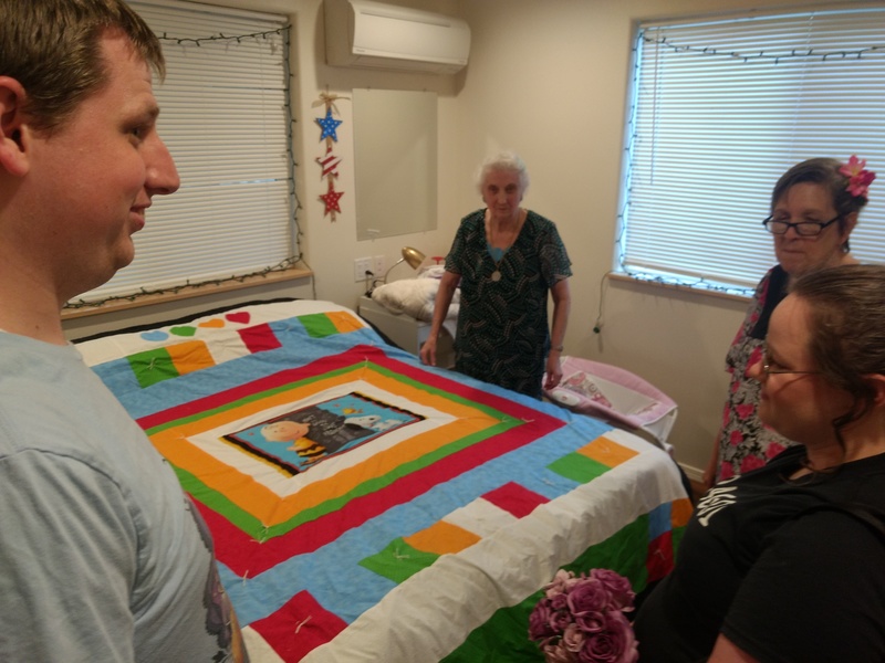 Cindy giving the quilt she made for Stephanie and Isaac to them.