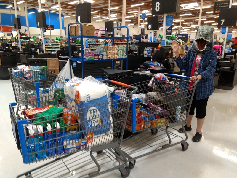T-Rex Cindy pushes two carts at Walmart.