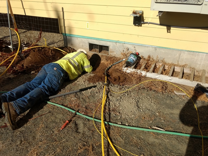 NW Natural Installation: Feeding the gas line back through the hog hole.
