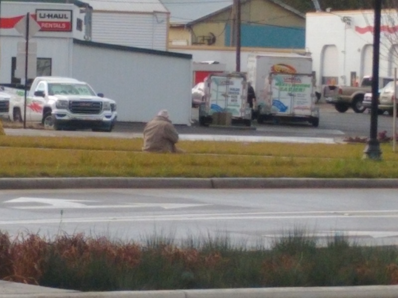Lois found an old "homeless guy" sitting on the curb in Springfield. Actually it was Don playing Pokemon. Lois looked up and saw this at laughed. She had to take a picture. Don is on an island in a busy street that has a round about next to it.
