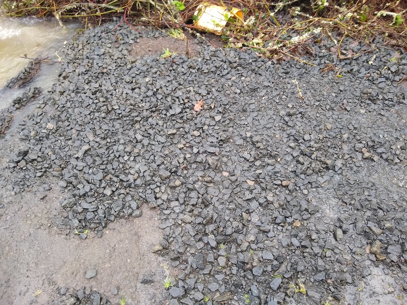 Tue 09:43 roadbed after the water has receded. Large gravel remains but smaller gravel has been scoured away.