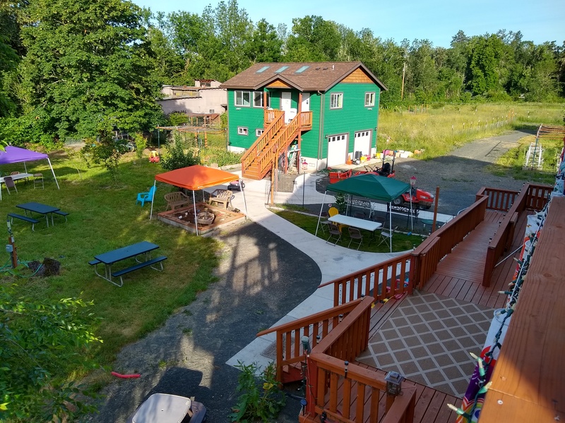 View of the picnic area, the guest house, and the back deck, from rm9d.