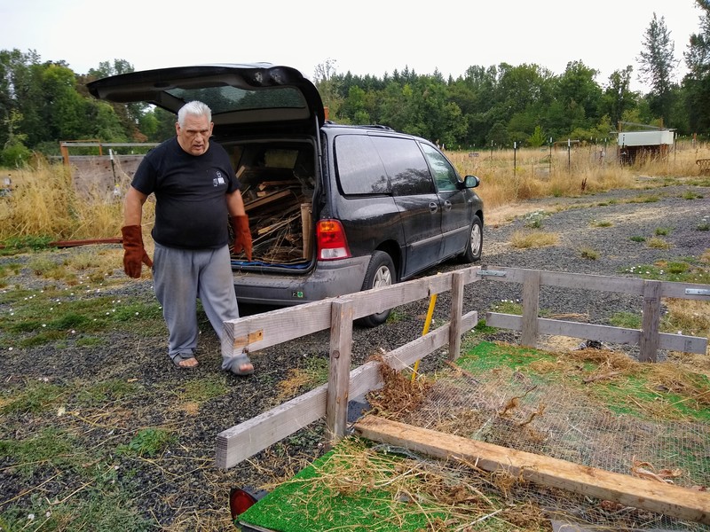 Don the Hulk loads up the back of the black minivan with chicken coop pieces.