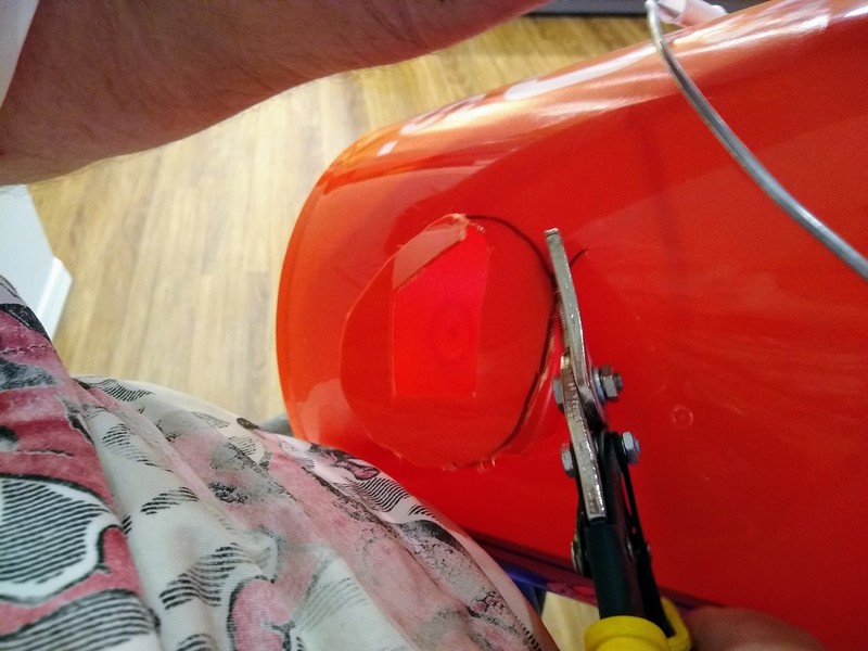 Cutting out a hole for the elbow in the feeding bucket.