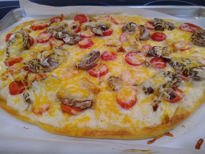 Finished Pizza. It was excellent. It had Alfredo, chicken, mushrooms, tomato, and cheese.