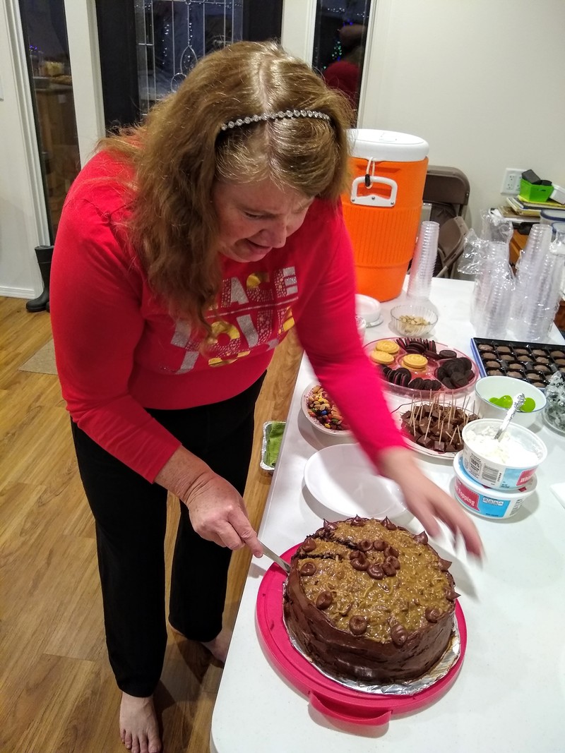 Lois cuts the German Chocolate birthday cake.